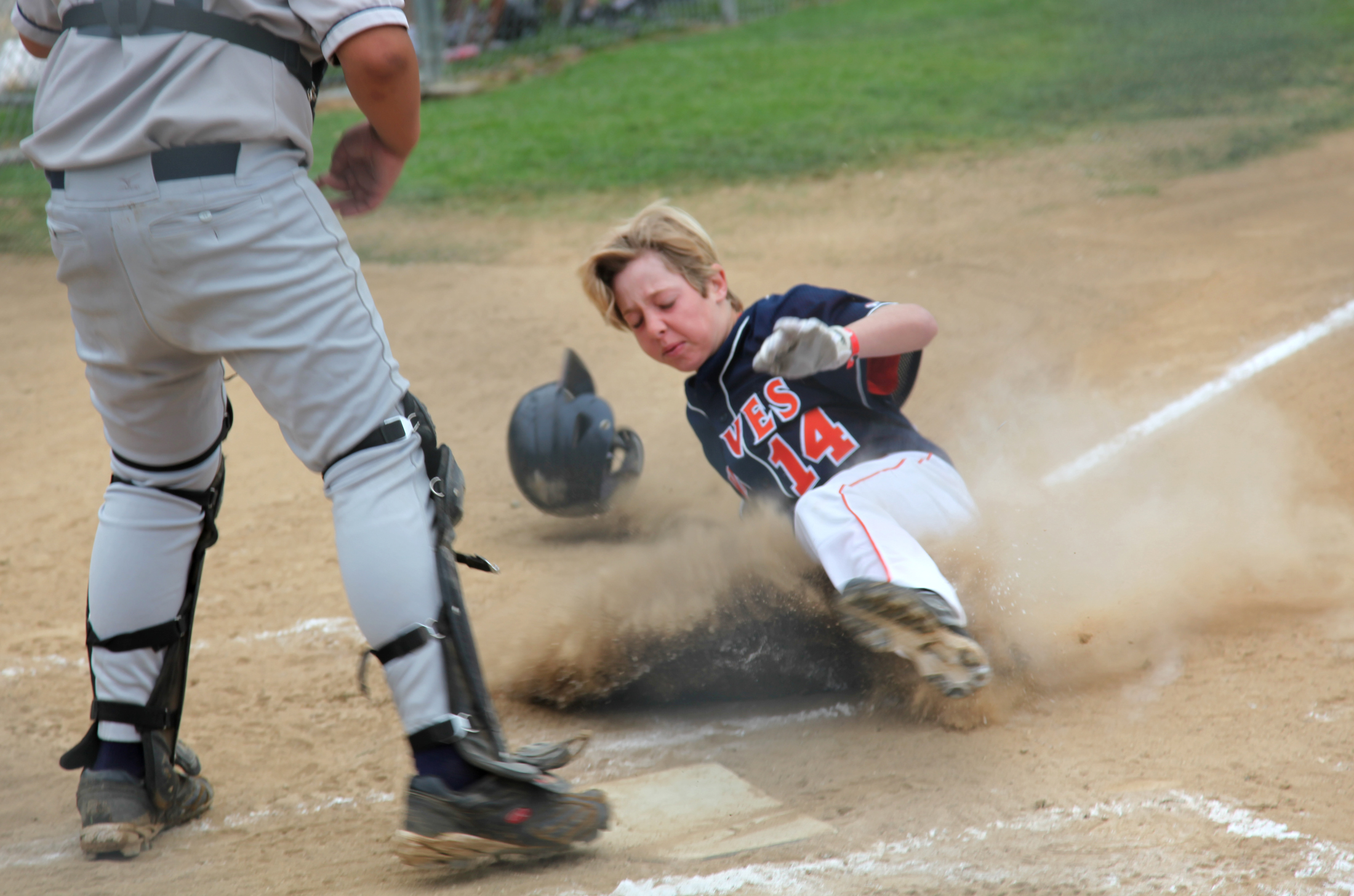 Cade Christensen slides home safely during the Waves' run to the La Canada Summer Splash championship last weekend.